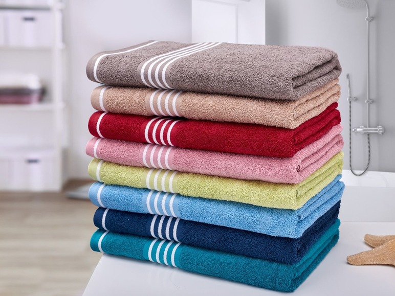 Kôpka uterákov v rôznych farbách s pruhmi.
