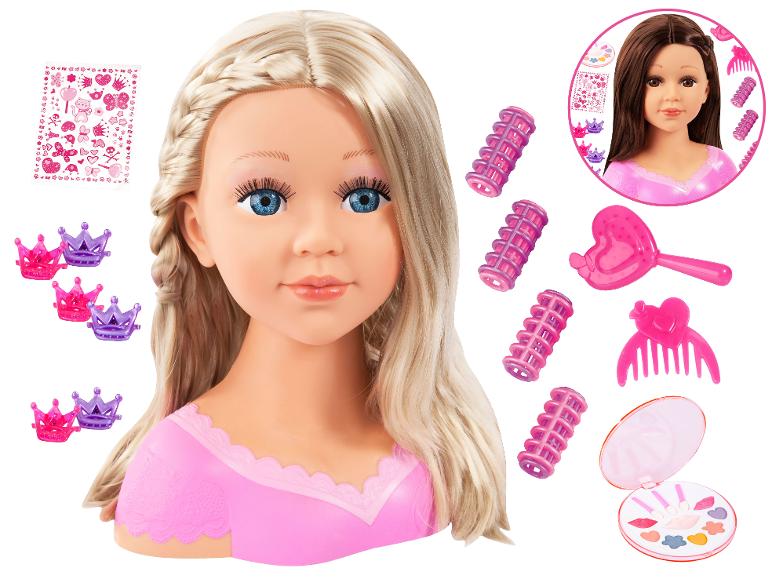 Blond stylingová hlava s make-upom, natáčkami, hrebeňom, kefou, korunkovými sponkami a nálepkami.