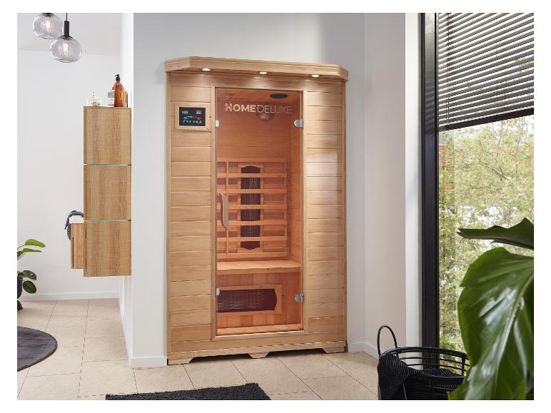 Infrasauna HOME DELUXE v modernej kúpeľni s drevenými skrinkami a rastlinami.