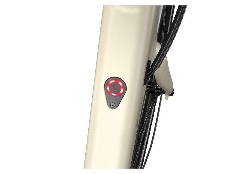 Detail krémovej elektrickej bicykle s červeným tlačidlom zapnutia/vypnutia.