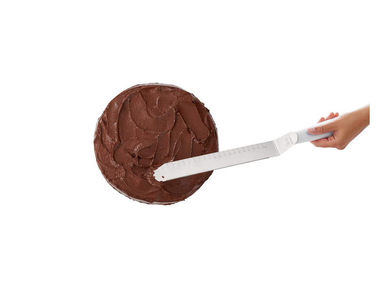 Čokoládový koláč sa vyhladzuje spatulou značky Ernesto.