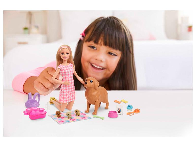 Bábika Barbie a hračky pre psov s dievčaťom hrajúcim sa v pozadí.