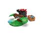 Súprava LEGO Duplo s čiernym dinosaurom, zelenými stromami a hnedou krabicou s modrými doplnkami.