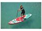 Žena vesluje na nafukovacom paddleboarde Exotic 10'6″ s kvetinovým vzorom.