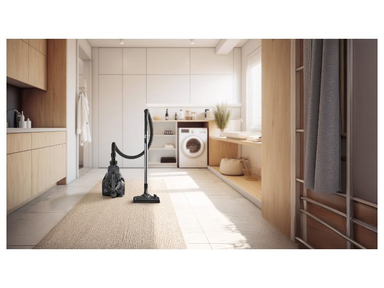 Vysávač na koberci v modernej práčovni.
