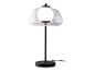 Moderná stolová lampa s priehľadným skleneným tienidlom a čiernou základňou.