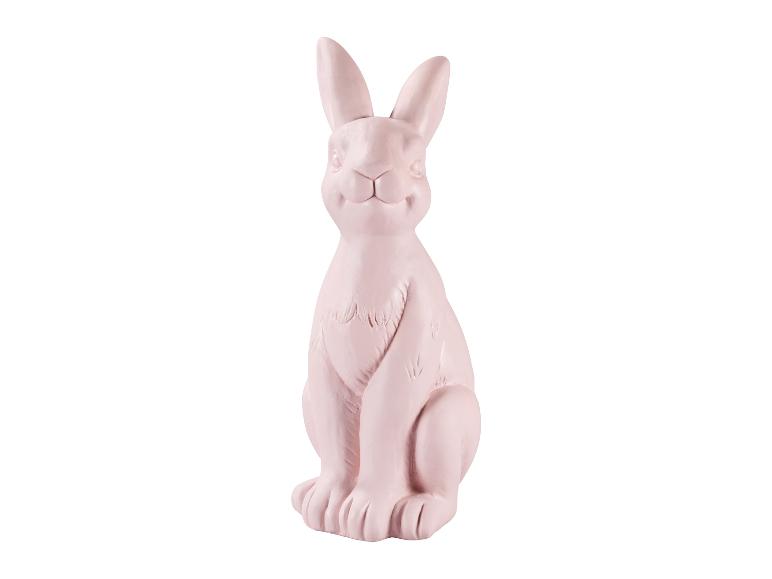 Svetloružový keramický sediaci dekoratívny zajac na Veľkú noc.
