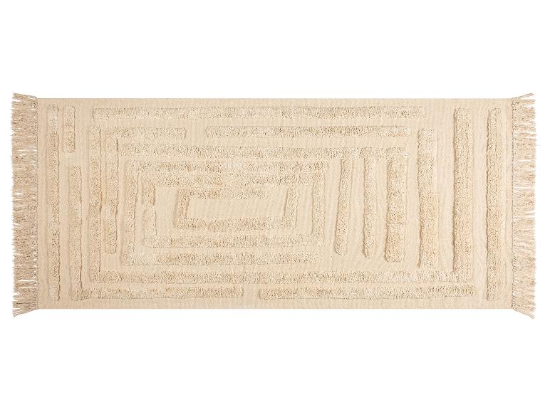 Béžový obdĺžnikový koberec s reliéfnym geometrickým vzorom a strapcami.