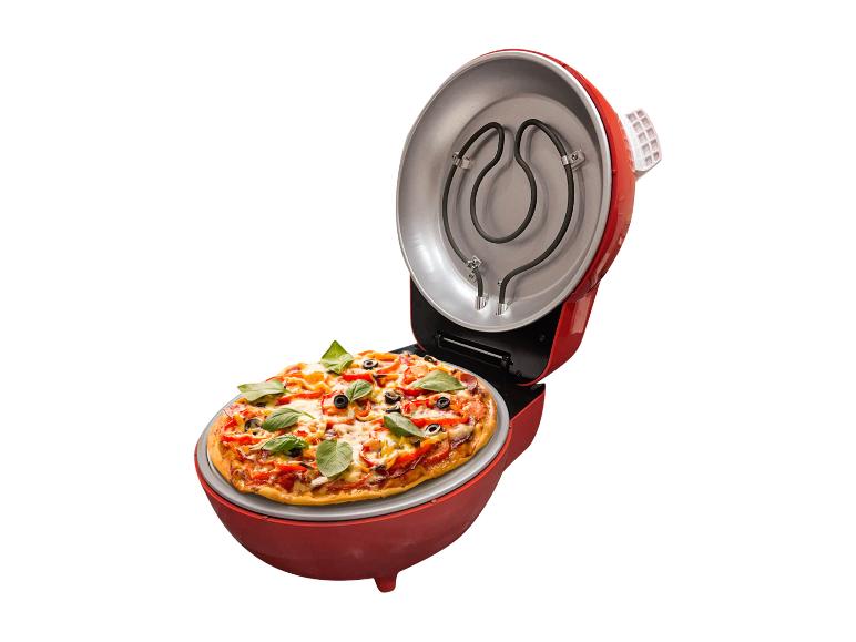 Pizza v červenej elektrickej rúre na pečenie pizze.