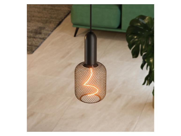 Závesná lampa s vláknovou žiarovkou v obývacej izbe so zelenou pohovkou a rastlinou.