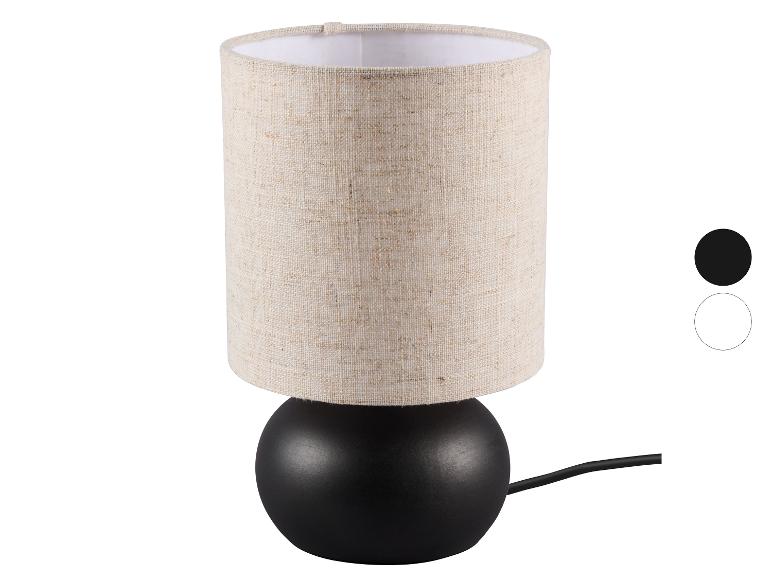 Stolná lampa s béžovým látkovým tienidlom a čiernou základňou, s farebnými možnosťami.