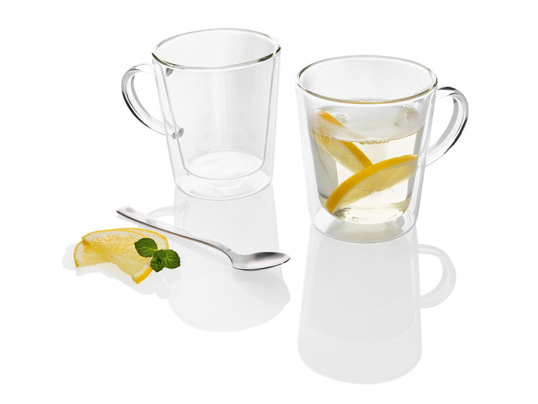 Dve sklenené hrnčeky s lyžičkou, z ktorých jeden je naplnený citrónovou šťavou.