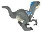 Plastová figurka dinosaura velociraptora v sivej farbe s modrými detailmi.