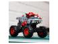 Sivý a červený model monster trucku s veľkými kolesami a žraločími zubami.