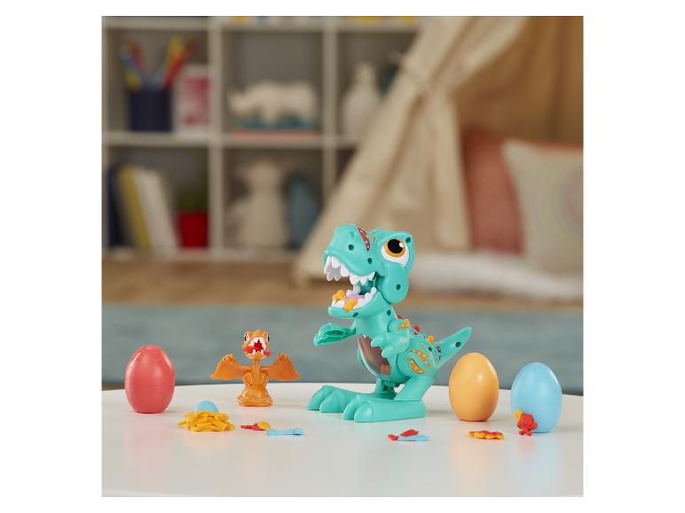 Hračka dinosaura s vajíčkami a malými dinosaurami.