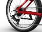 Detail zadného kolesa červeného bicykla, zobrazujúci prehadzovačku, kazetu a reťaz.