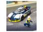 Lego policajné auto a minifigúrka na ceste v daždi.