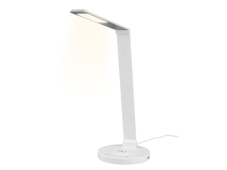 Biela LED stolná lampa s bezdrôtovou nabíjačkou.