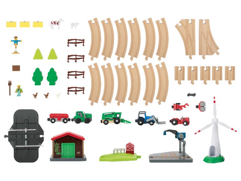 Súprava hračkárskeho vlaku s farmárskou tematikou, s koľajnicami, vozidlami a príslušenstvom.