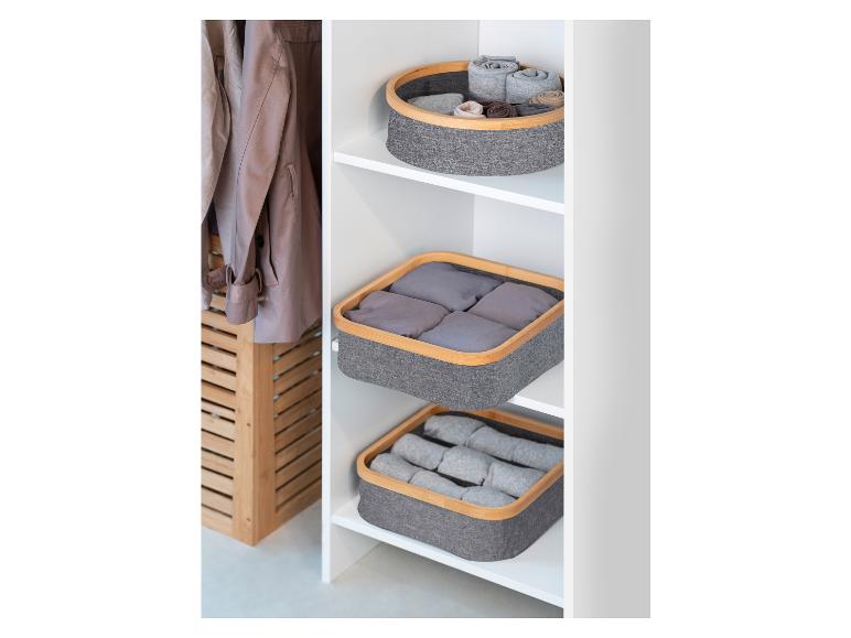 Šedé úložné koše s bambusovým okrajom v skrini.