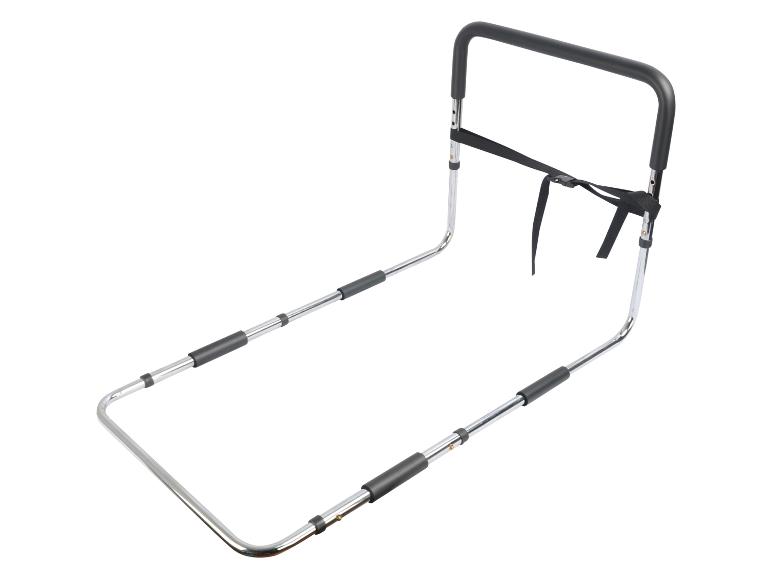 Chrómovaná kovová posteľná opierka s čiernou rukoväťou a upevňovacím popruhom.