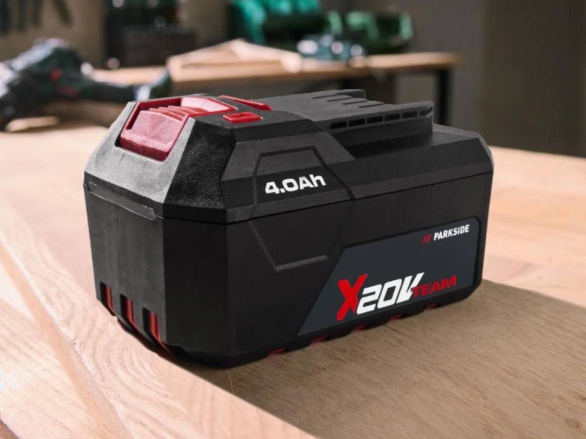 Čierna batéria s červenými akcentmi a nápisom '4.0Ah X20V TEAM' na drevenom stole.