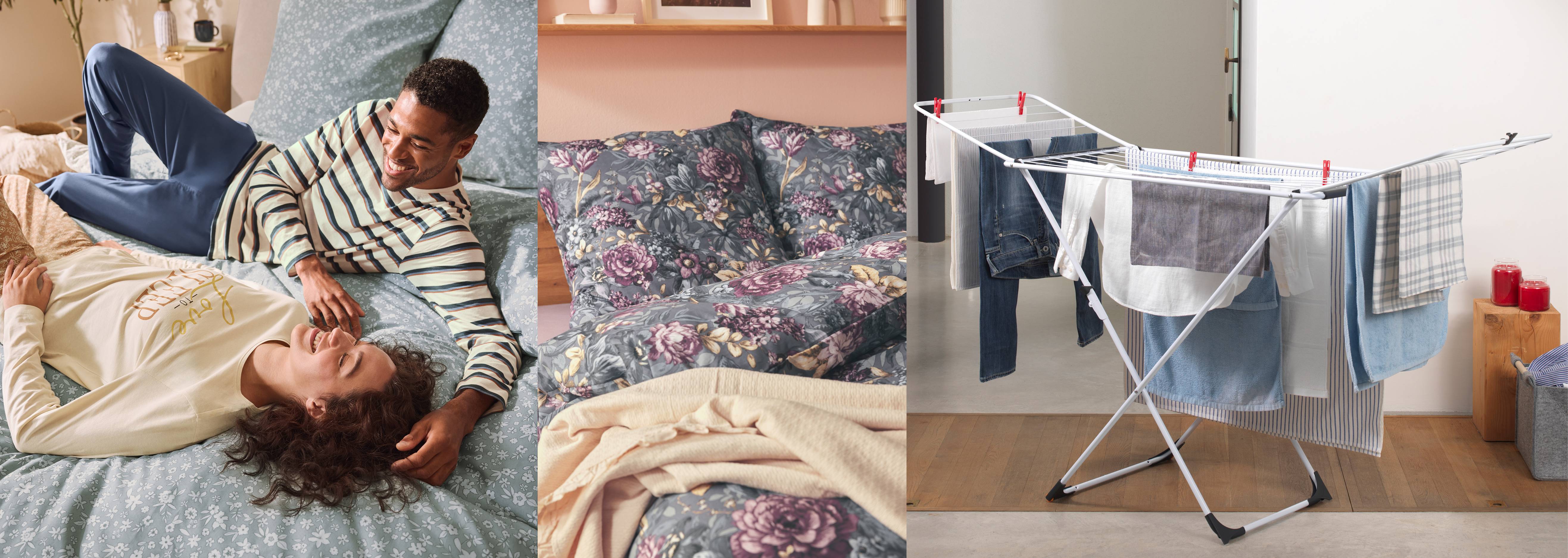 Pár v pyžame na posteli s kvetinovými obliečkami a sušiak na bielizeň s uterákmi.